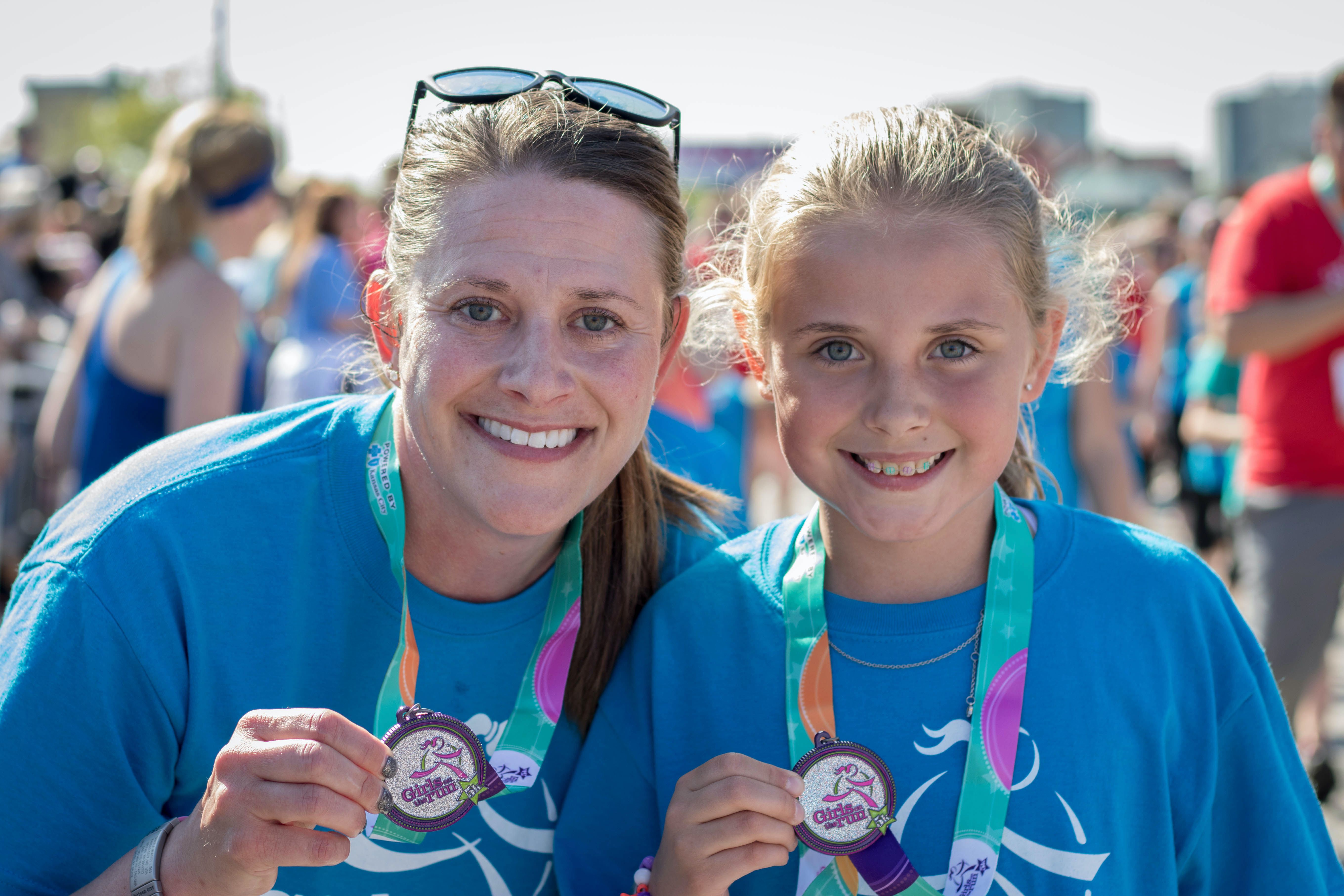 Girls on the Run participant wearing hajib with rainbow painted on cheek